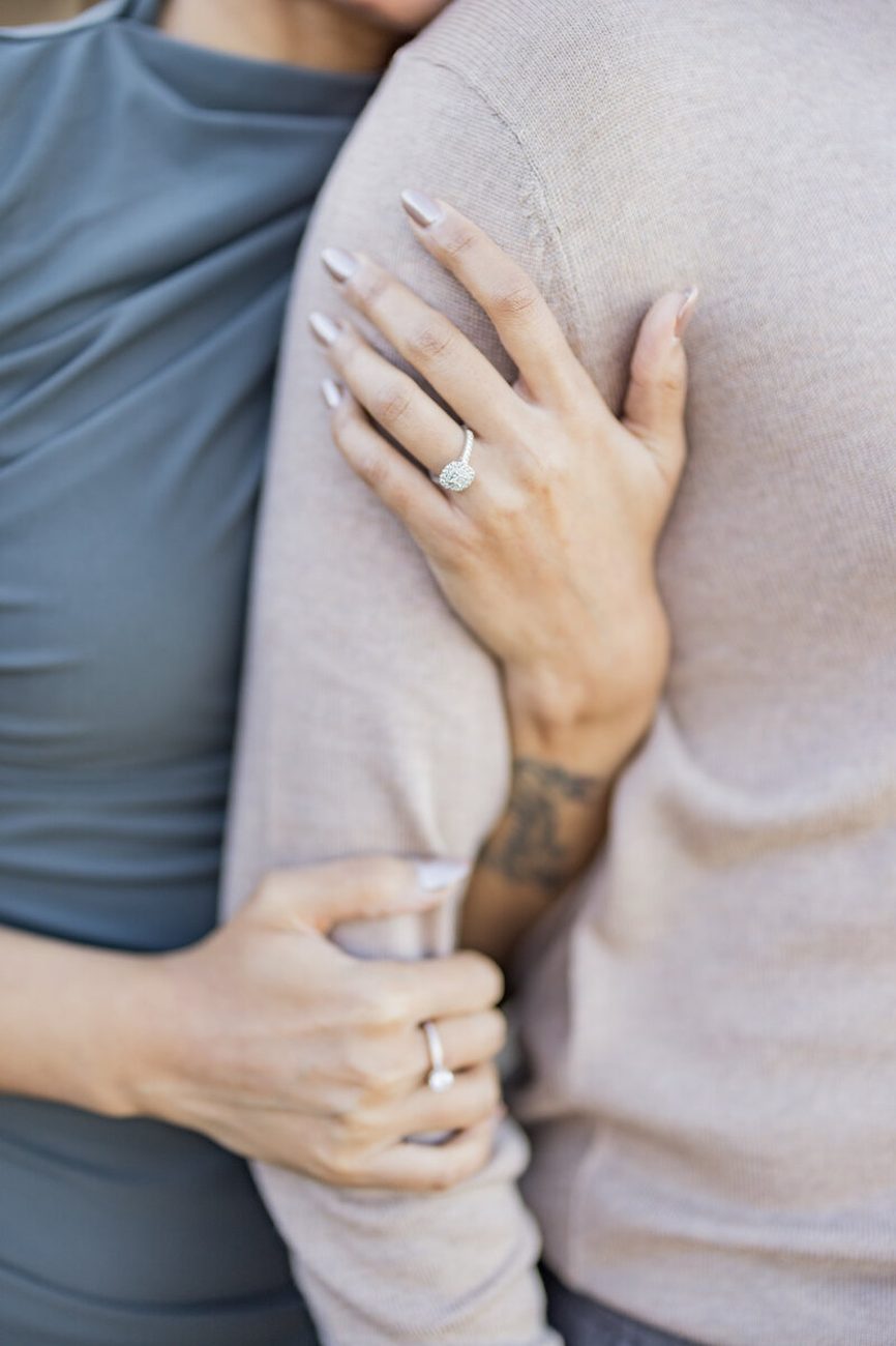 Engagement ring close-up on intertwined arms